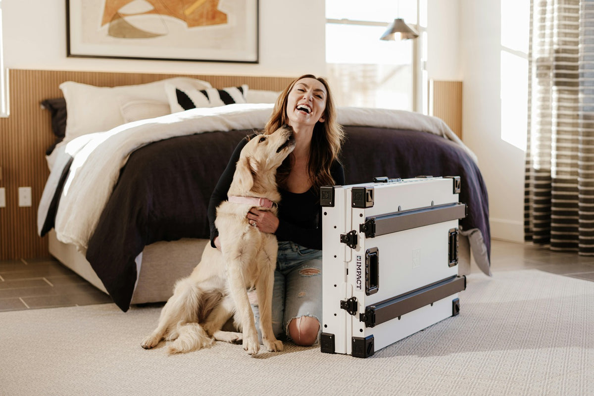 Woman and dog with a pet gate in a bedroom