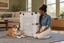 A Bulldog resting beside an Impact Collapsible dog crate.