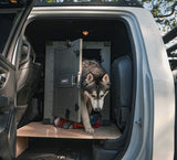 husky exiting high anxiety impact dog crate in truck cab